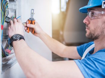 Electric Technician Job. Caucasian Professional Electrician in His 30s Finishing Electric Box Inside the Apartment.